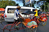 Riding the becak, the local cycle rickshaws in Malioboro street Yogyakarta. 